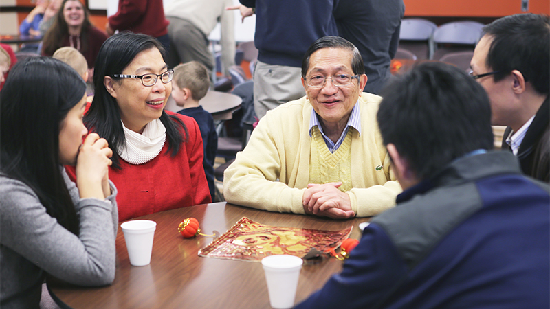 Small group of people at a table talking